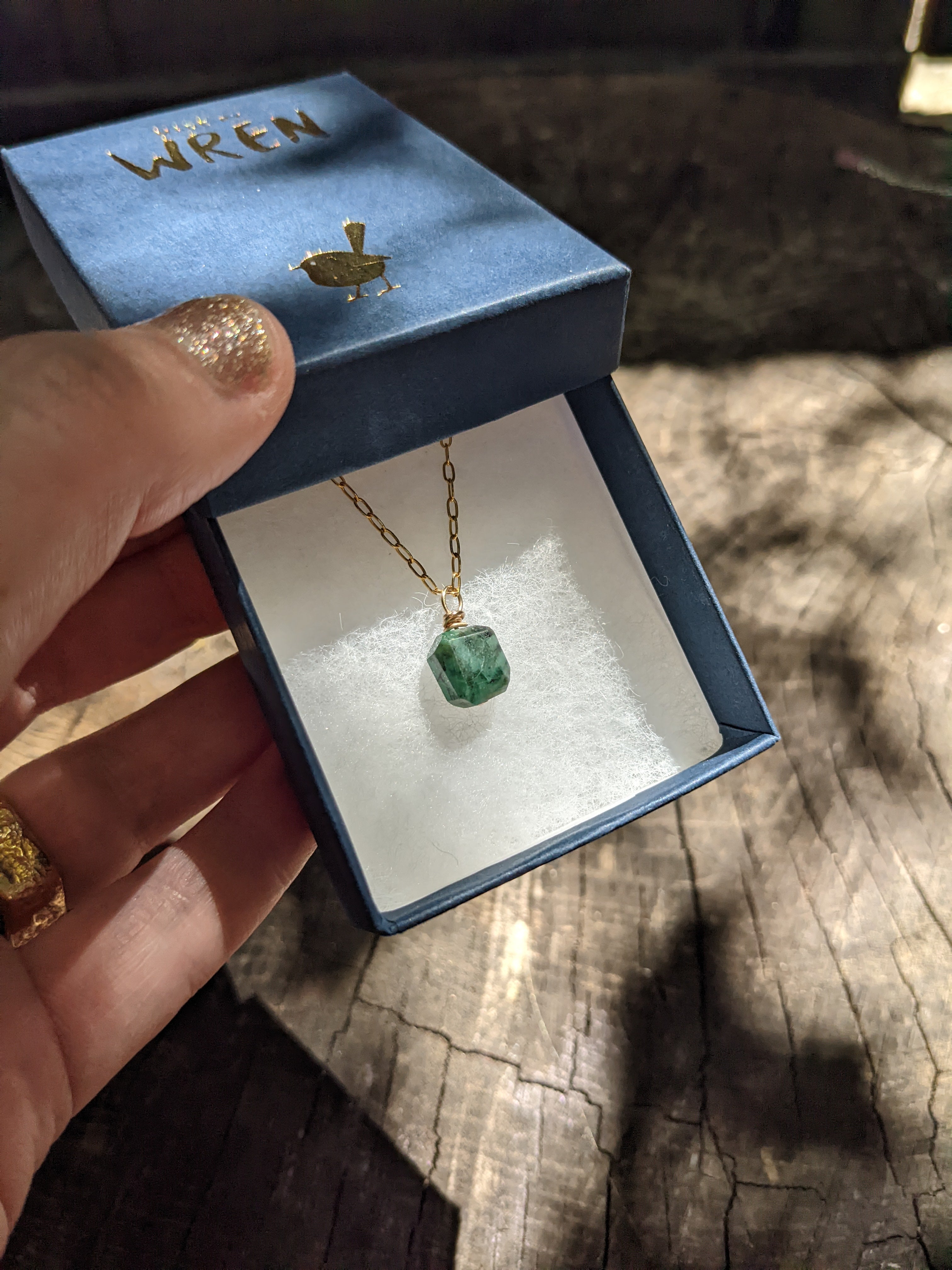 Emerald wire wrapped gold pendant